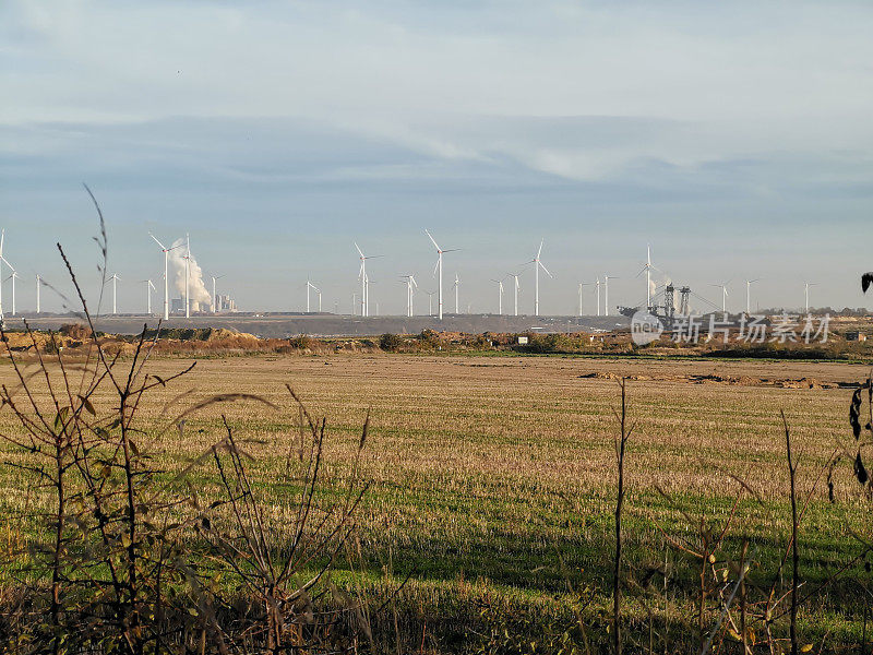Wind turbines and fossil energy generators on the horizon seen from Lützerath